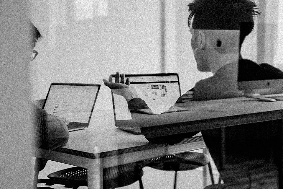 Two coworkers on their laptops